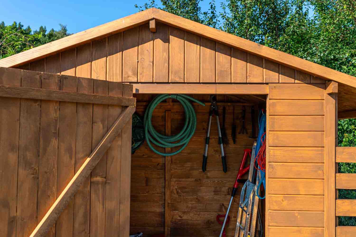 a-wooden-garden-shed-standing-on-a-concrete-founda-2026-03-24-01-19-11-utc