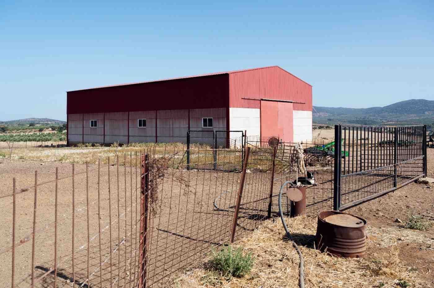 Red metal barn in open field