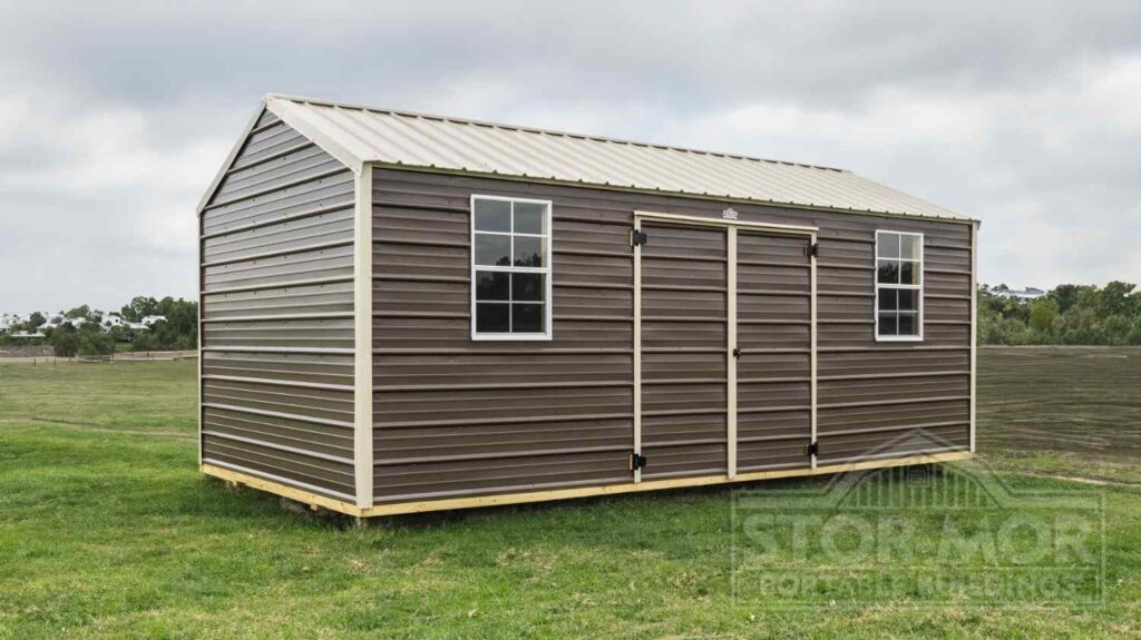 Dark brown metal utility storage shed featuring cream trim, central double doors, two windows, and a beige metal roof in Lexington, Kentucky.