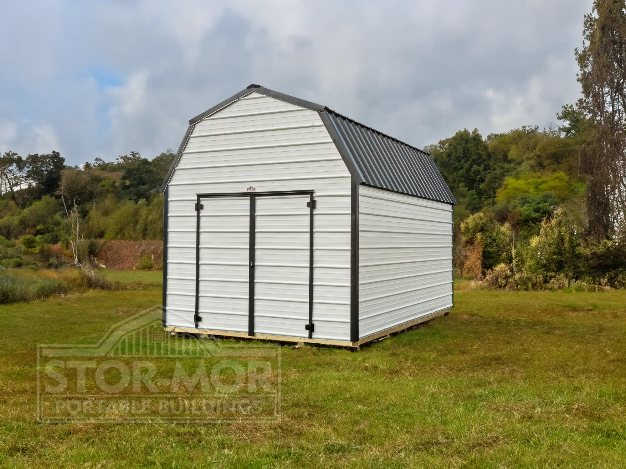 A white metal lofted barn shed with charcoal trim and double doors on a grassy field in Dallas, TX.