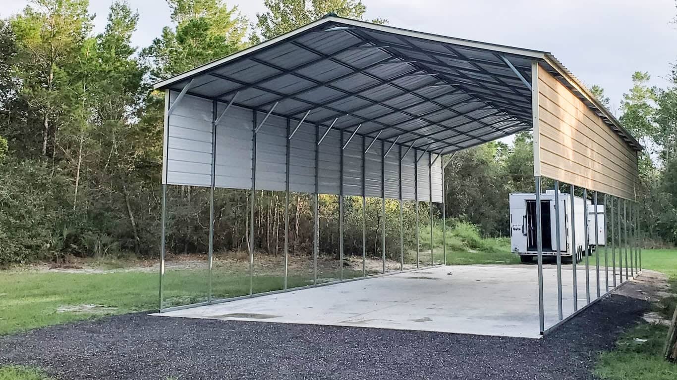 Tall extra-long metal RV carport cover with metal side panels built on a concrete slab in Chiefland, FL.