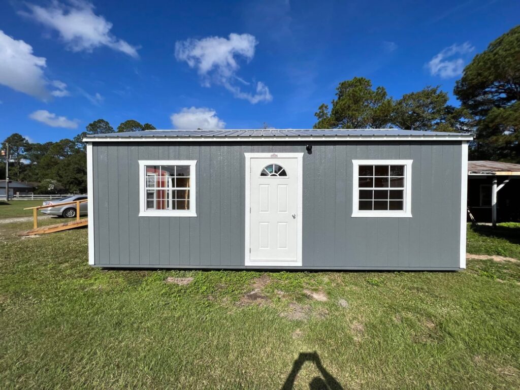 Gray storage shed with white door