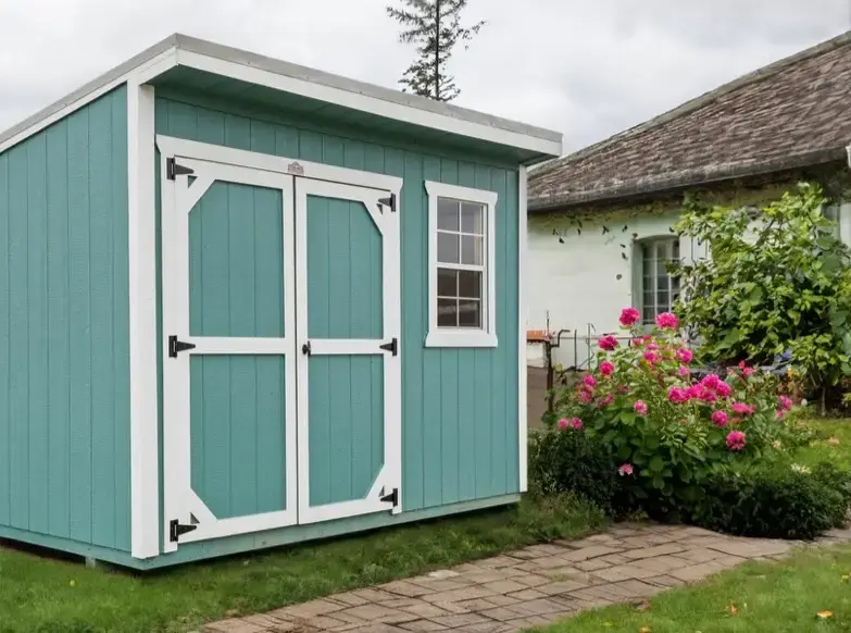 Teal blue modern lean-to storage shed with white trim, double doors, single framed window, and stone walkway in Crystal River, FL.