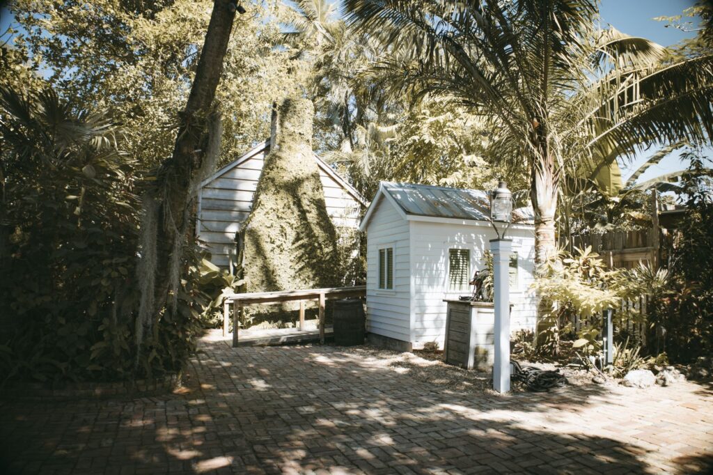 The Complete Outdoor Shed Guide for Florida Homeowners 1 outdoor shed with wraparound porch in a Florida backyard