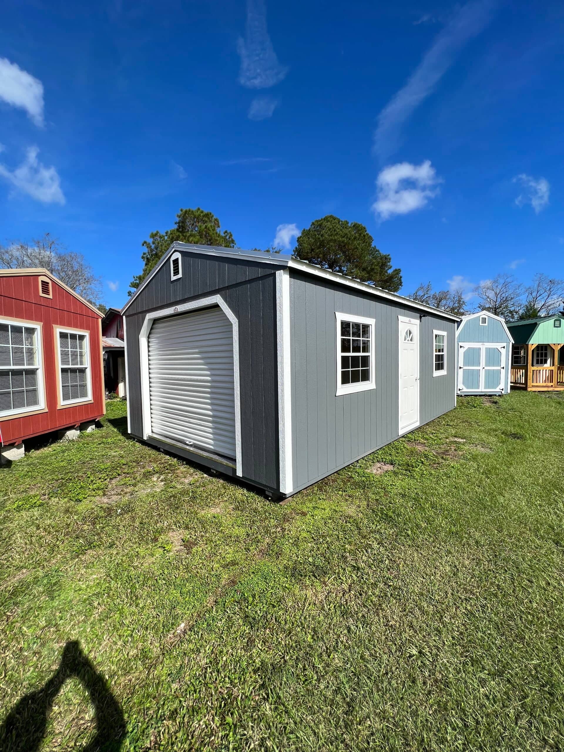 Gray storage shed with white accents