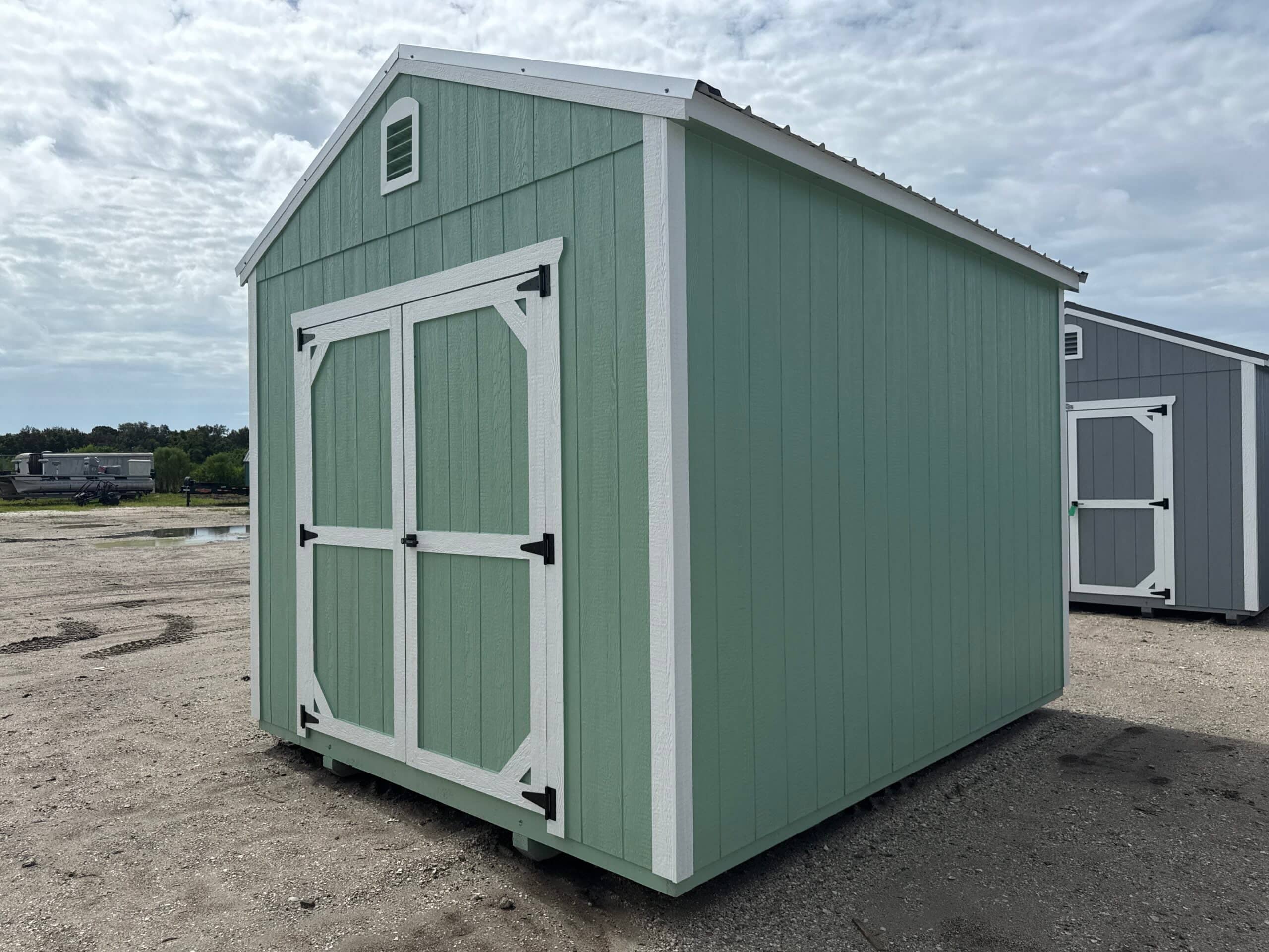 Green wooden shed with double doors